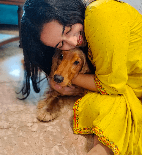Tanishq hugging a dog